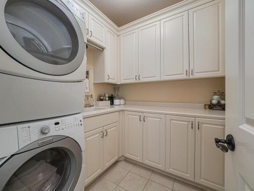 Laundry room with Utility sink, An electric dryer as well as a gas hookup & Built in shelving
