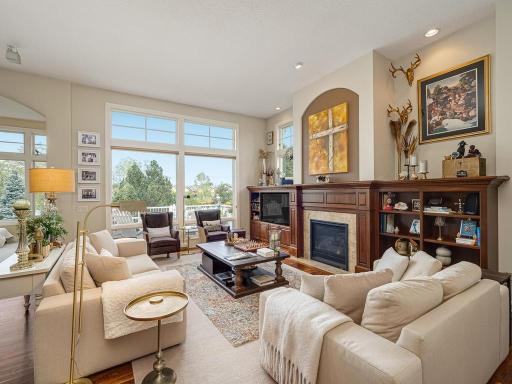 Welcoming Great room with Gas Fireplace with natural woodwork, Large picture windows