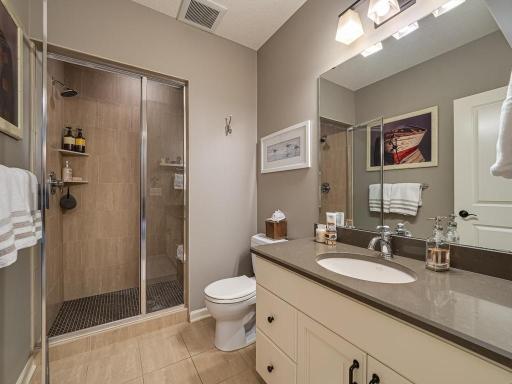 Lower level 3/4 bath with fully enclosed walk in shower that can be treated as a steam shower, Fan directly above the shower to catch the steam
