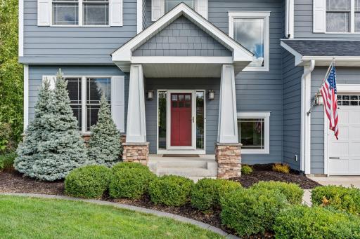 Quality craftsmanship is evident from the moment you arrive, with a welcoming front porch and beautifully finished exterior details.