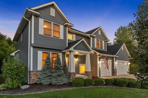 Upgraded landscaping and lush greenery surround the home, creating a beautiful setting from the front yard to the backyard.