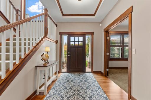 A warm and welcoming entry showcases beautiful hardwood floors, classic millwork, and the thoughtful craftsmanship found throughout the home.