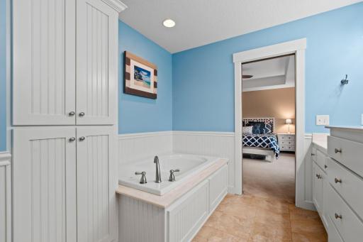 Relax and unwind in the separate soaking tub, part of a thoughtfully designed private primary bath.