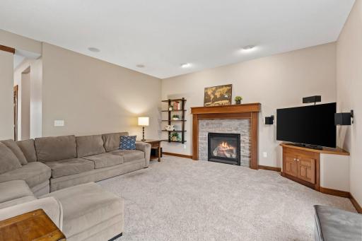 A warm, comfortable gathering space with classic millwork and a cozy gas fireplace at its center.