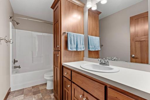 The full upper-level bath conveniently serves the secondary bedrooms and features a spacious vanity with abundant cabinetry and a tub/shower combination.