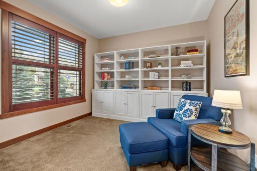 A dedicated main-level office features beautiful built-in cabinetry and bookshelves, creating a polished and functional work-from-home space.
