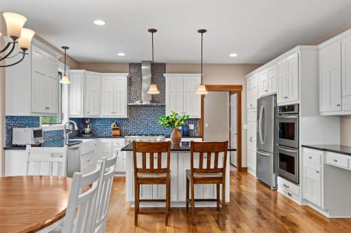 A fabulous kitchen designed for those who love to cook, featuring abundant cabinetry, granite countertops, high-end appliances, and a large center island.