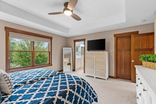 Large windows bring in abundant natural light, while the private en-suite bath and walk-in closet are conveniently located just steps away.