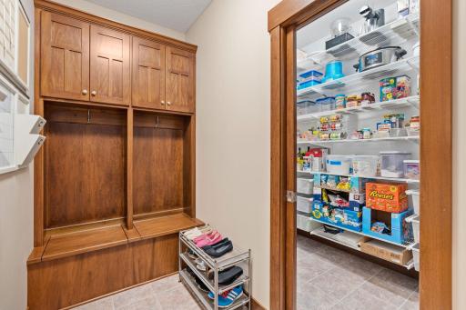 An exceptionally functional mudroom features custom built-in cubbies and cabinetry to keep everyday essentials organized.