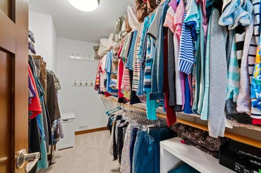 A spacious walk-in closet offers excellent storage and organization within the private primary suite.