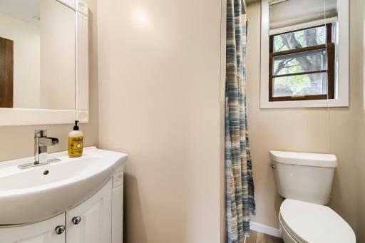 Convenient lower-level three-quarter bathroom with a clean, updated vanity.