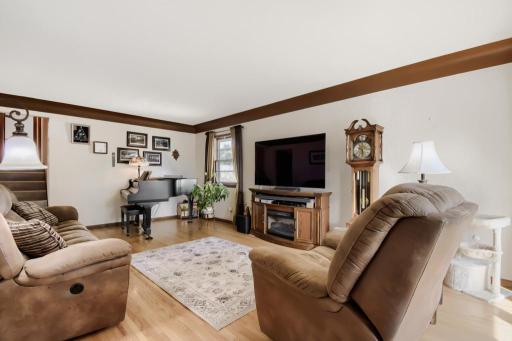 Bright and spacious living room featuring gleaming hardwood floors and a beautiful bay window.