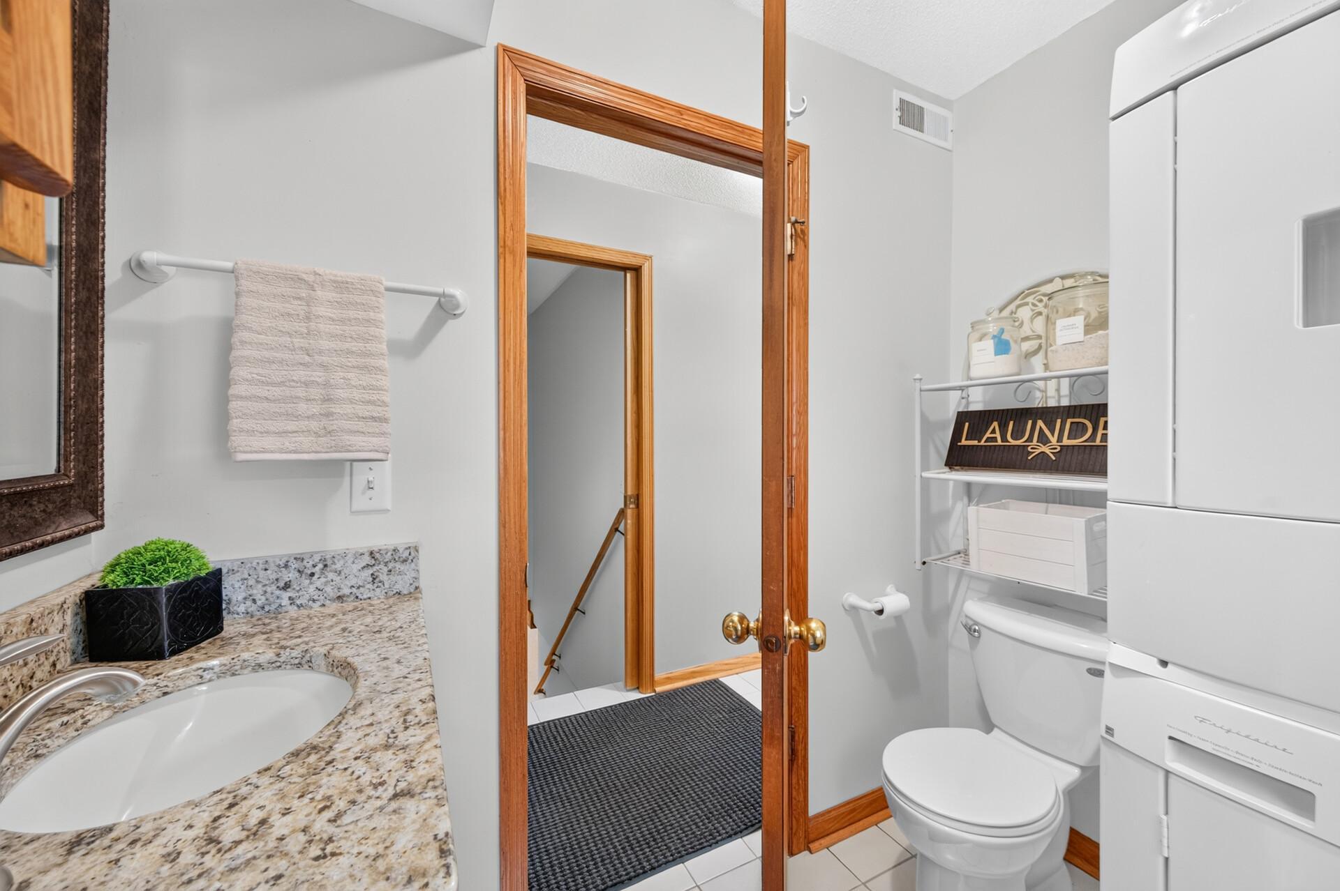 Main level 1/2 bath is shared with laundry room.