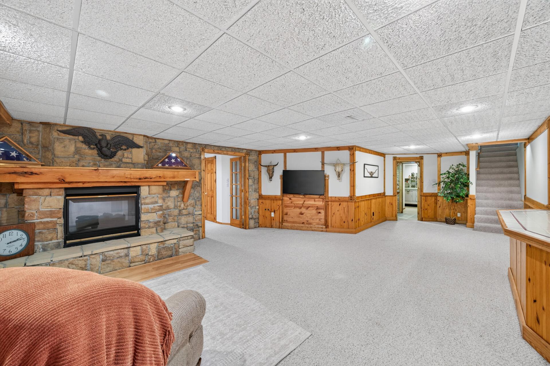 Stunning stone fireplace is double sided.