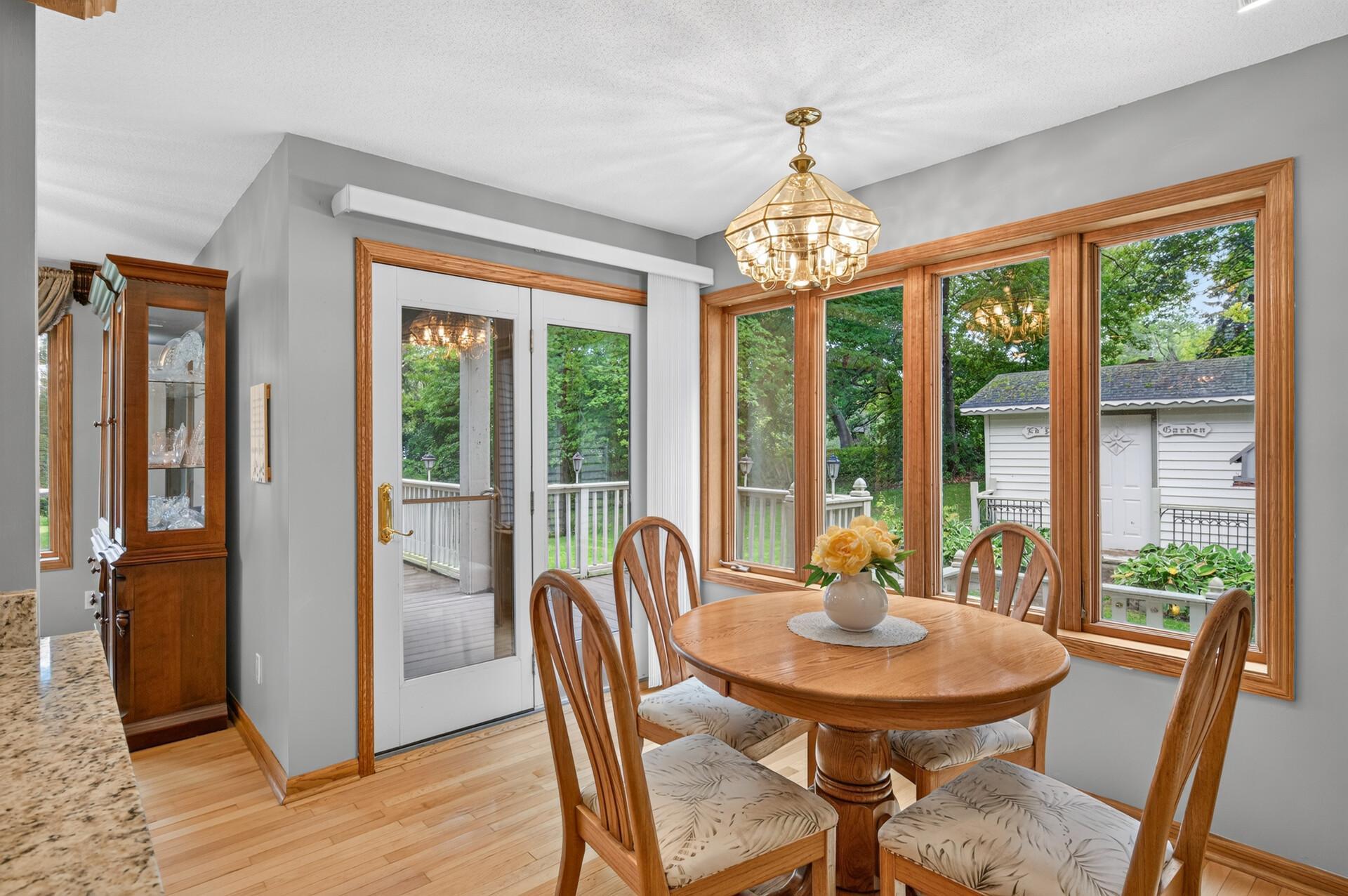 Informal dining space is brightened by 2 walls of windows.