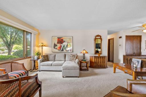 The heart of the home, replacement windows (2018-2022) flood the home with natural light, highlighting rich oak woodwork and updated upper and lower carpet (2021).
