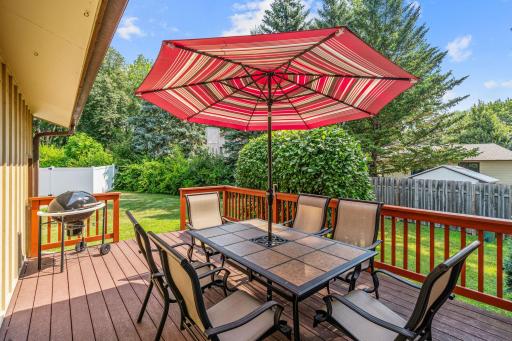 From the dining room, sliding glass doors open directly to a maintenance-free composite deck (2008) framed by mature evergreen privacy landscaping.