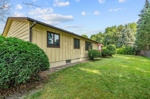 The word "green" is best suited in describing the outdoor space and landscaping around this home.
