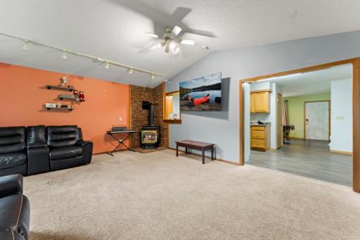 Fireplace with chimney in living room. Vaulted ceilings and double doors to the screened in porch