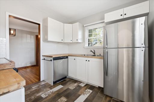 Updated kitchen with newer soft close cabinetry, butcher block countertop and stainless steel appliances.