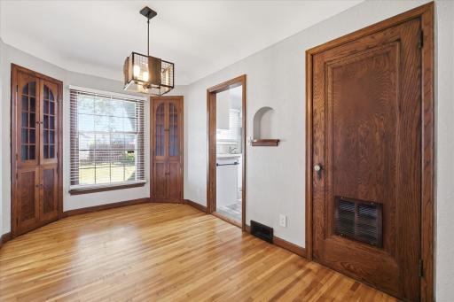 Lovely dining space with two built in hutches. Door to the right leads upstairs to the bedroom.