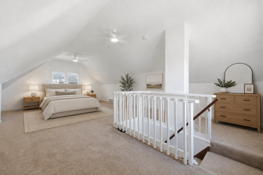 Head upstairs to the third bedroom with two ceiling fans! Plenty of space to configure your furniture how you'd like it. Virtually staged photo.