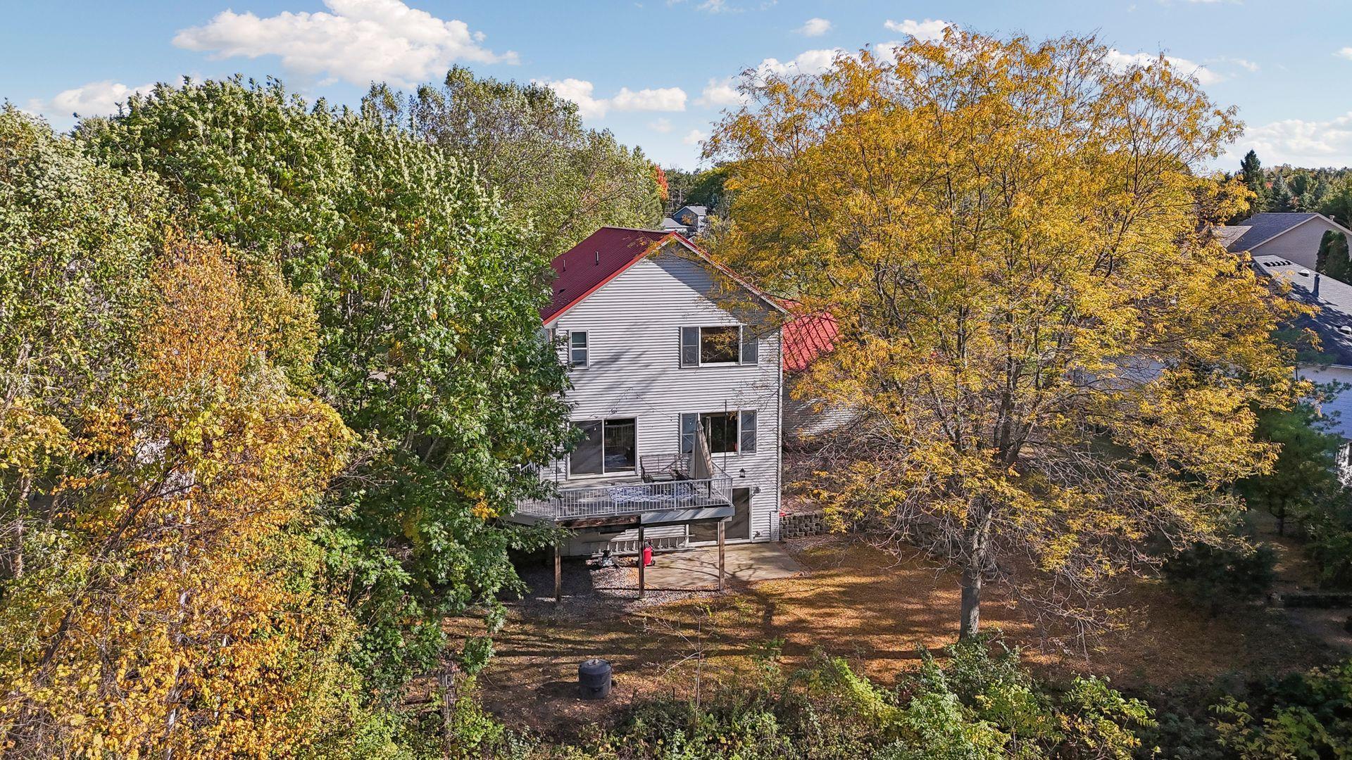 An aerial view showcases the expansive backyard and picturesque pond, offering beautiful views right outside your door.