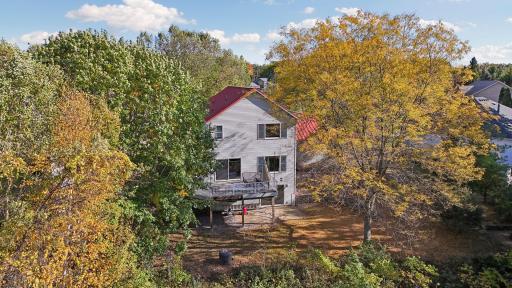 An aerial view showcases the expansive backyard and picturesque pond, offering beautiful views right outside your door.