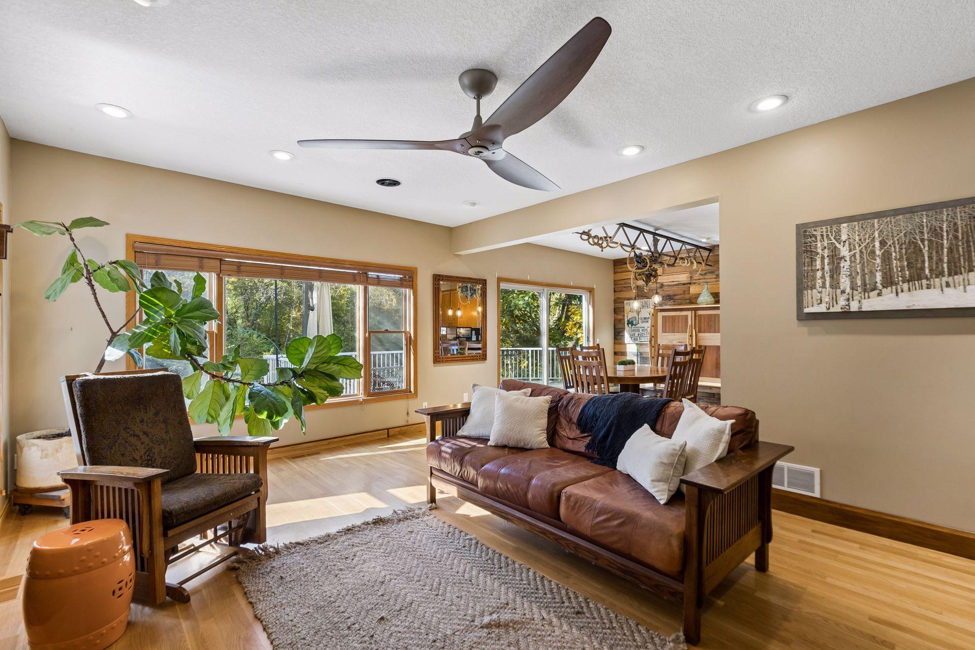 The living room overlooks the peaceful pond and private backyard, seamlessly connecting to the kitchen and dining area for effortless entertaining.