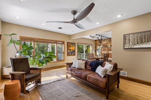 The living room overlooks the peaceful pond and private backyard, seamlessly connecting to the kitchen and dining area for effortless entertaining.