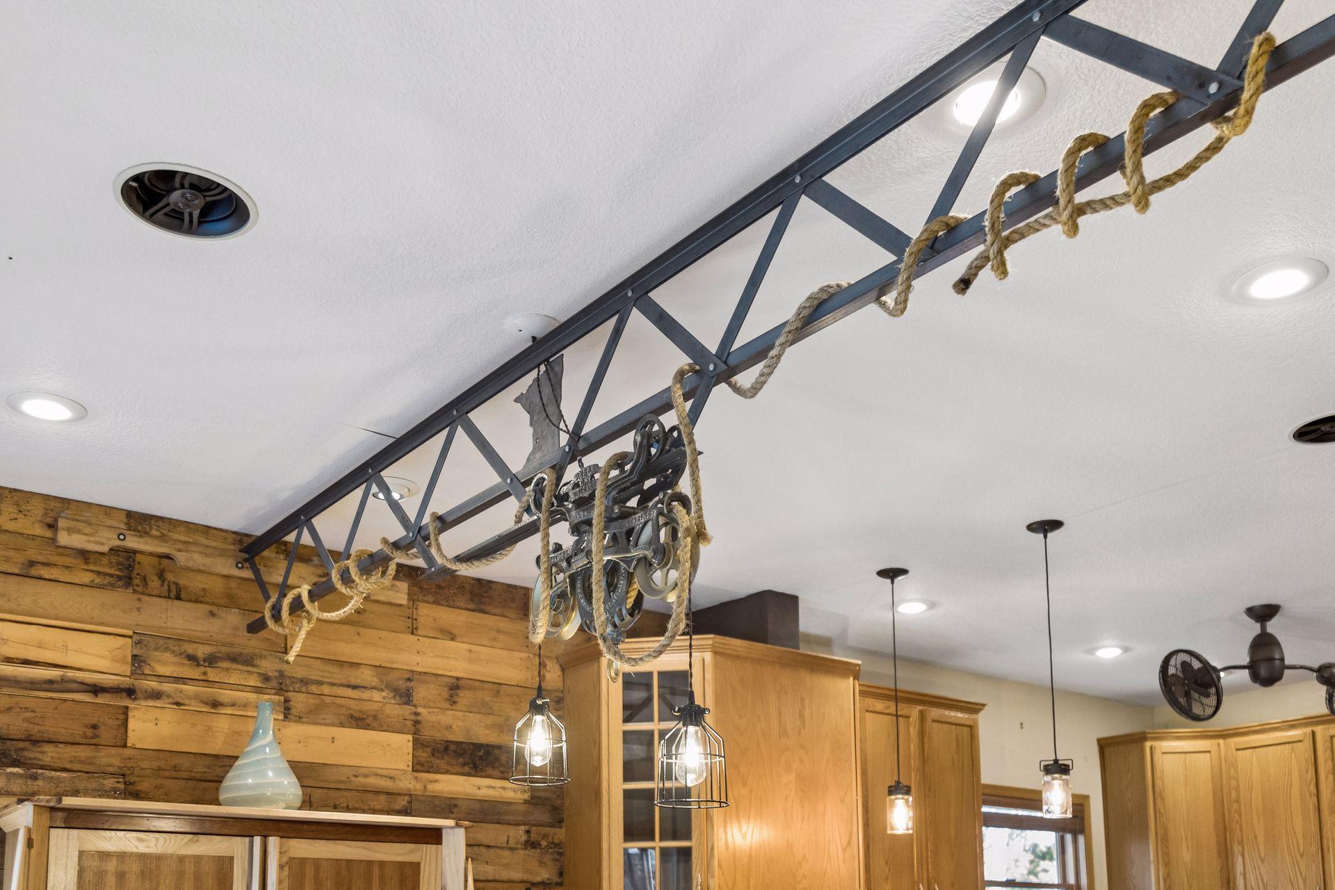 One-of-a-kind custom lighting inspired by the Stillwater Lift Bridge creates a stunning focal point in the kitchen.