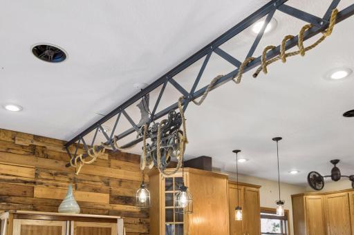 One-of-a-kind custom lighting inspired by the Stillwater Lift Bridge creates a stunning focal point in the kitchen.
