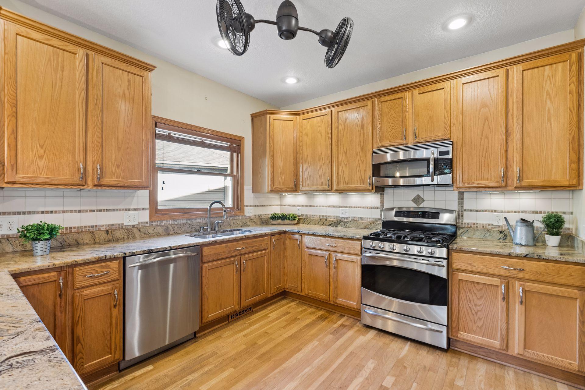 Gorgeous woodwork, a beautiful kitchen window, and thoughtful finishes make this kitchen as inviting as it is functional.