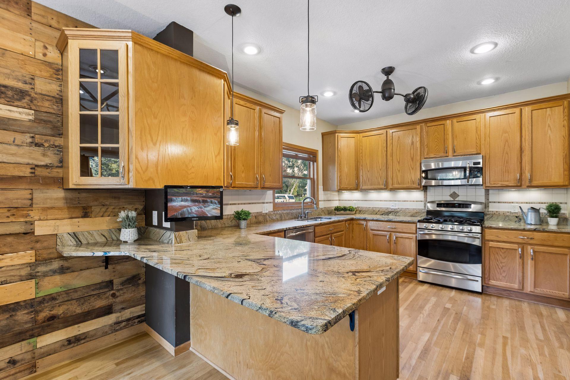 Welcome to this stunning kitchen, featuring an abundance of cabinetry, beautiful stone countertops, and exceptional space for cooking and entertaining.