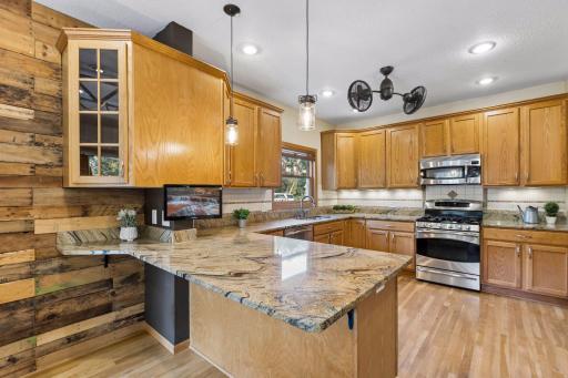 Welcome to this stunning kitchen, featuring an abundance of cabinetry, beautiful stone countertops, and exceptional space for cooking and entertaining.