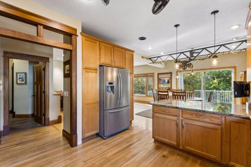 Natural light fills the kitchen, featuring generous pantry storage, a spacious refrigerator area, and a bright, welcoming atmosphere.