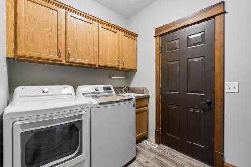 A functional main-floor mudroom and laundry area adds everyday convenience and keeps everything organized.