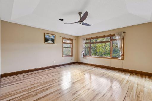 Retreat to the impressive primary suite, offering generous space and peaceful views overlooking the backyard pond.