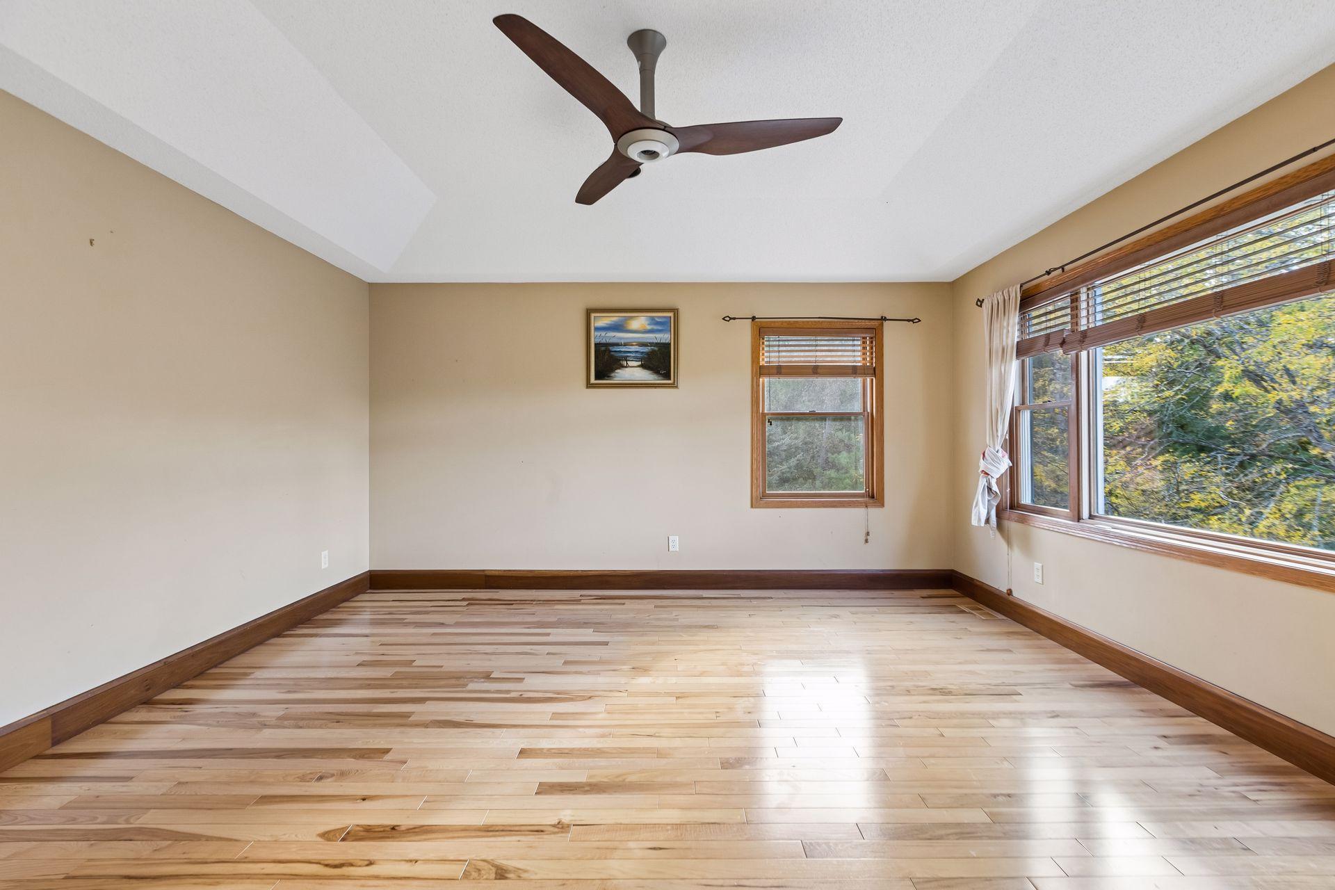 Gorgeous hardwood floors continue into the spacious primary bedroom, complete with a large walk-in closet.