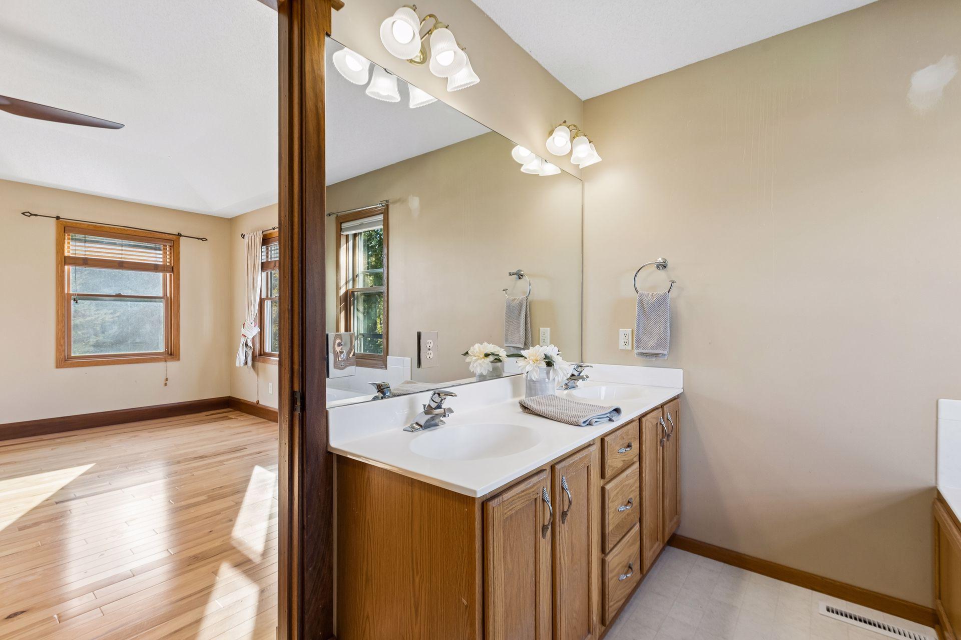 Double vanity sinks provide plenty of personal space and storage in the primary bathroom.
