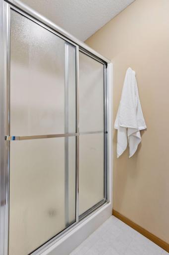 A spacious walk-in shower adds comfort and convenience to the beautifully appointed primary bathroom.