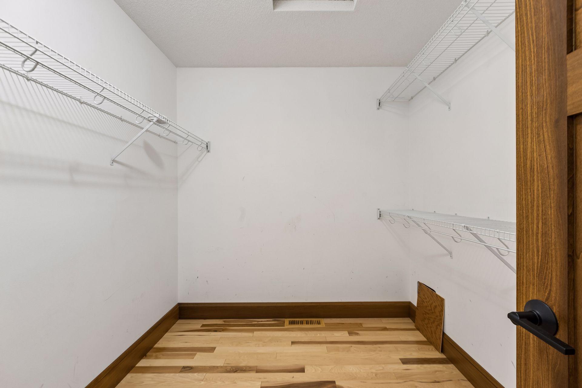 The primary suite's generous walk-in closet provides wonderful storage and organization.