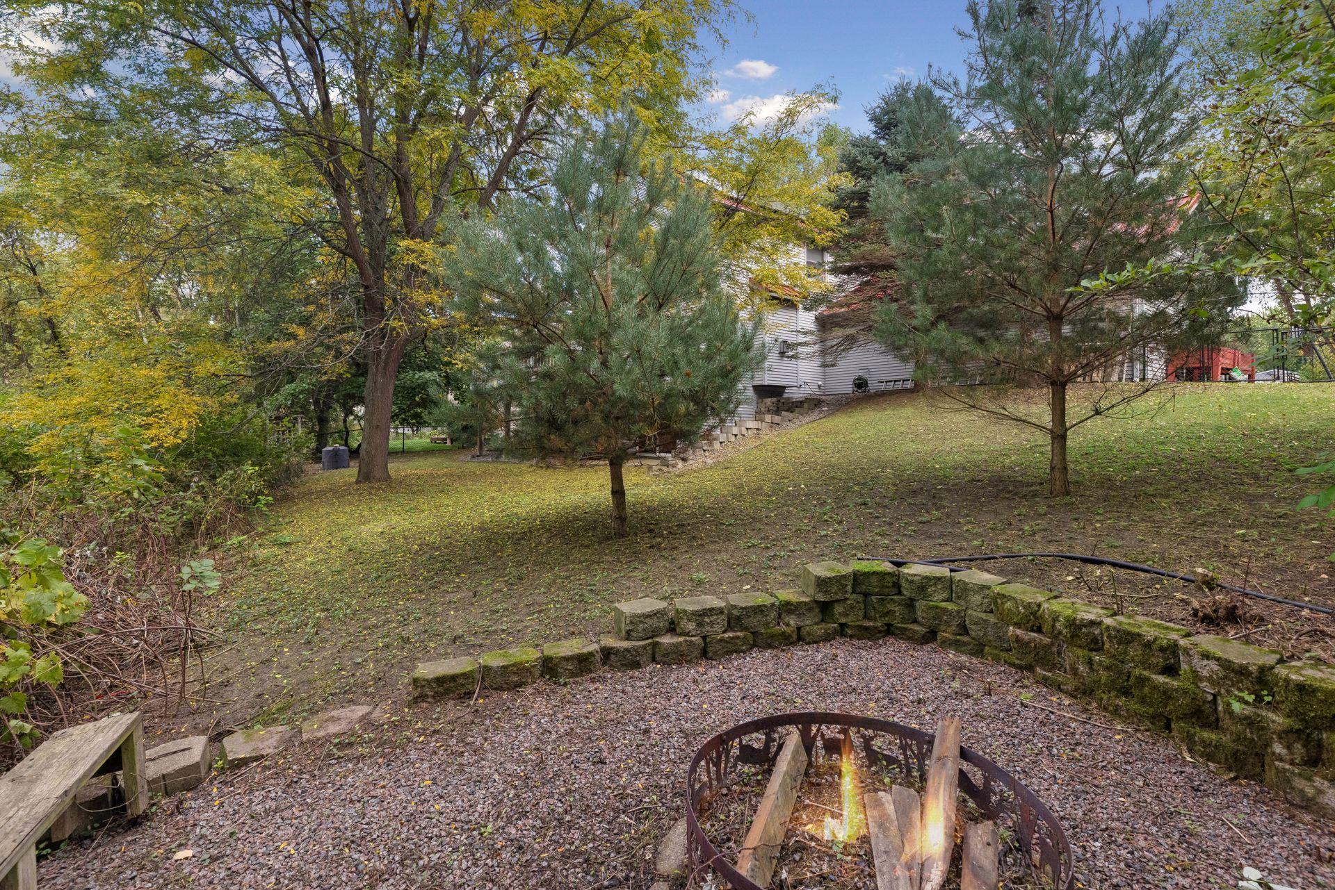 From the fire pit, take in the incredible backyard setting, surrounded by mature trees, open green space, and beautiful natural scenery.