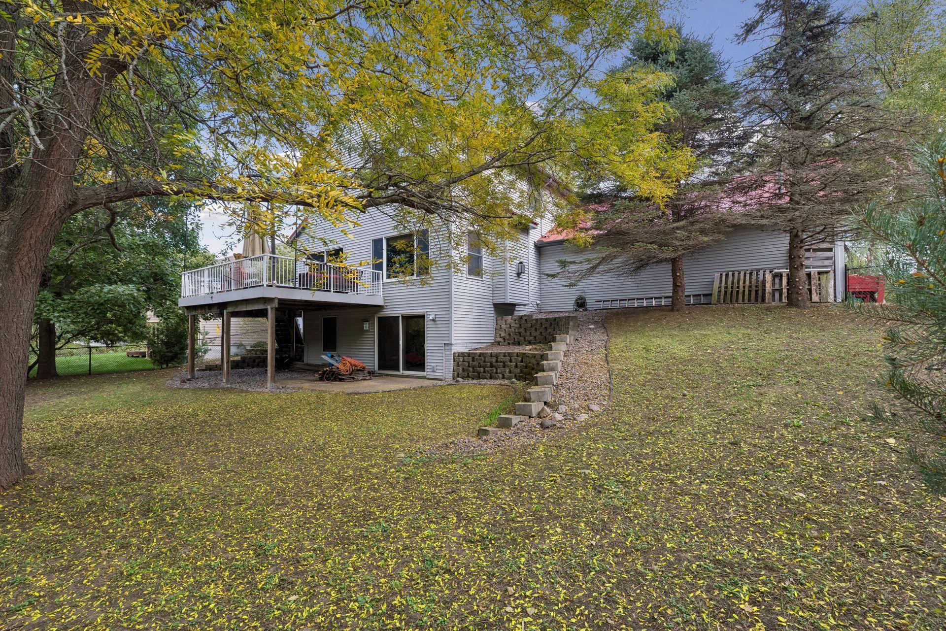 Looking back toward the home, you'll appreciate the expansive yard, impressive exterior, and spacious attached garage.