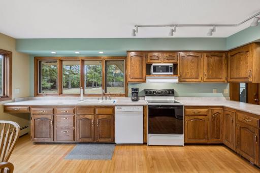 Natural light from many windows, hardwood floor continuing and tons of counter and cabinet space, make this kitchen a fantastic space for everyday cooking and entertaining.