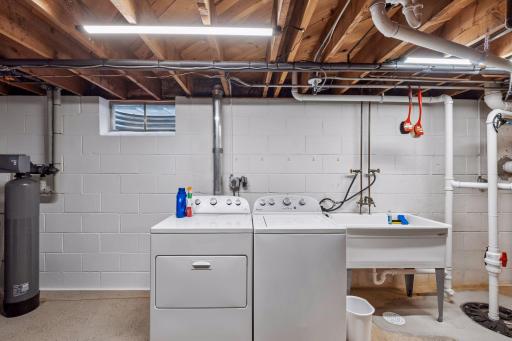 The laundry and mechanical room provides a utility sink (new 2026), generous workspace, and plenty of room for storage and everyday tasks. Basement was replumbed in 2026 to accomodate the addtion of a lower level bathroom