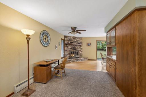 The wood burning fireplace adds warmth and character to both the formal dining room and casual dining area, creating a natural focal point between the two spaces.