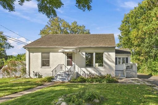 Stone-Coated Metal Roof, Welcoming Front Entry & Lush Tree-Lined Yard
