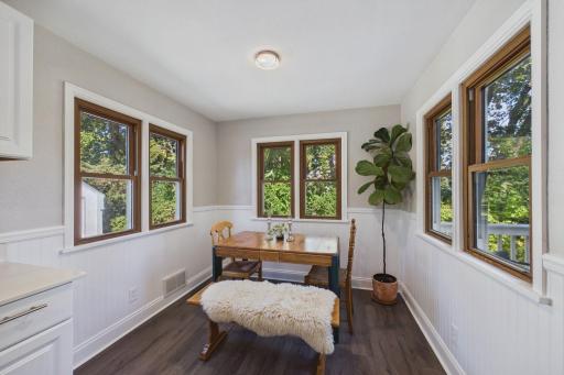 Dining Area with Three-Sided Windows & Lush Greenery Views