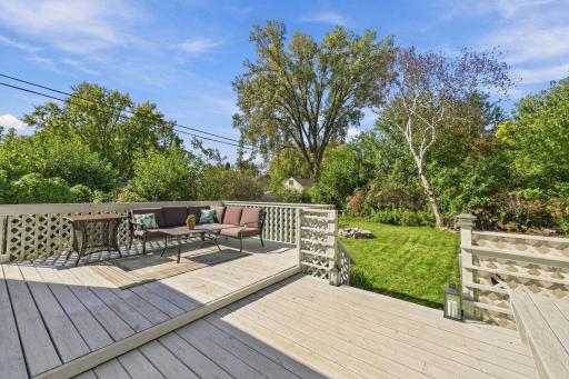 Spacious Backyard Deck Surrounded by Lush Greenery